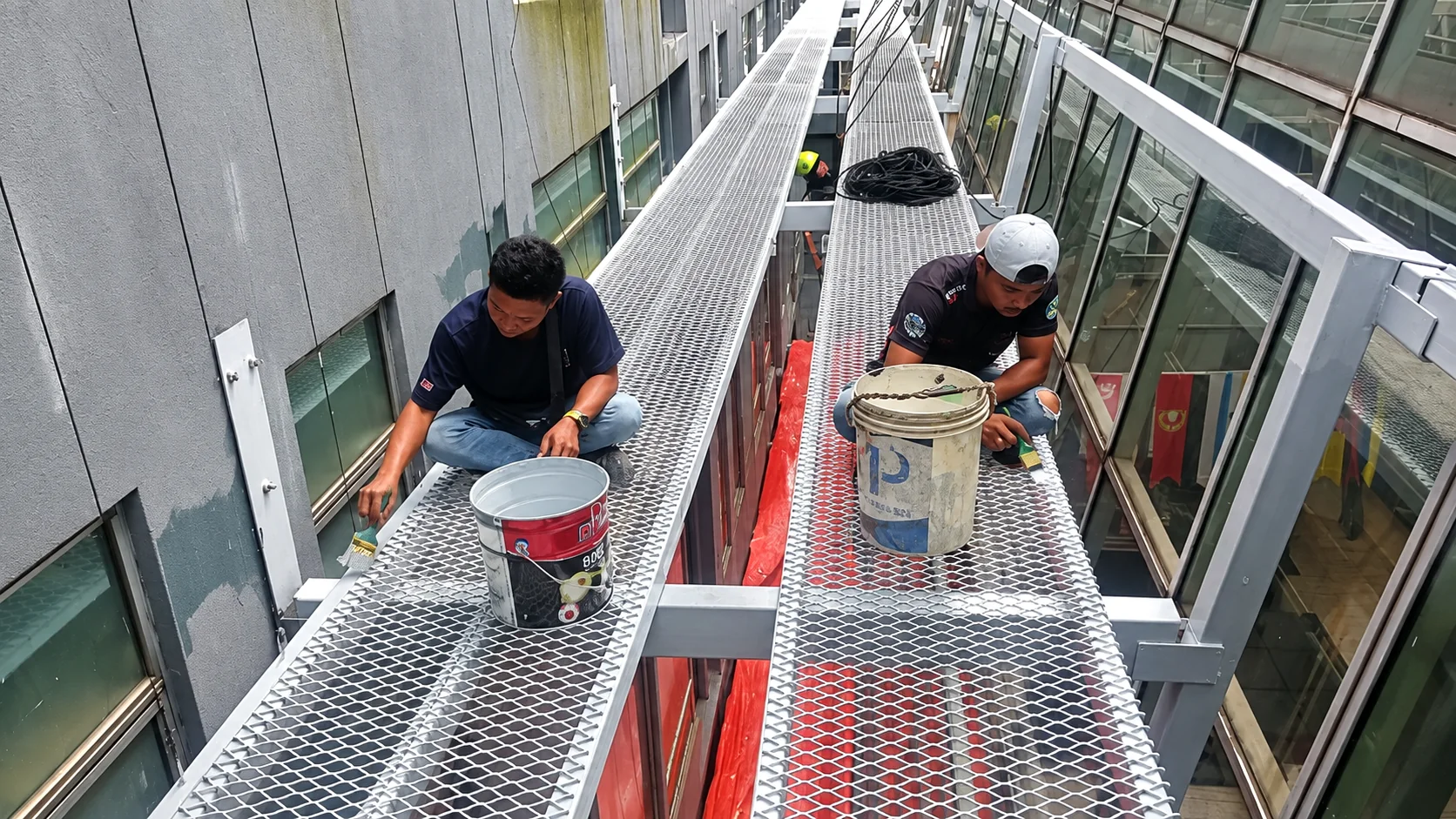 Commercial facade painting by rope access technicians